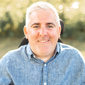 headshot of muscular dystrophy forum moderator Patrick Moeschen against a green background