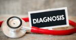 Limb-Girdle MD Diagnosis | Muscular Dystrophy News | Image of red stethoscope and small label that reads 'diagnosis'