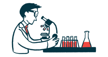 A scientist looks into a microscope.