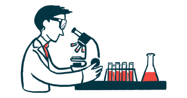 A scientist looks into a microscope.