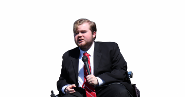 Elijah Stacy | Muscular Dystrophy News Today | DMD | photo of Elijah Stacy in a wheelchair giving a speech