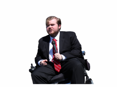 Elijah Stacy | Muscular Dystrophy News Today | DMD | photo of Elijah Stacy in a wheelchair giving a speech