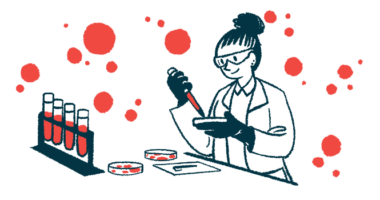 A scientist uses a dropper and a petri dish to test blood samples in a laboratory.