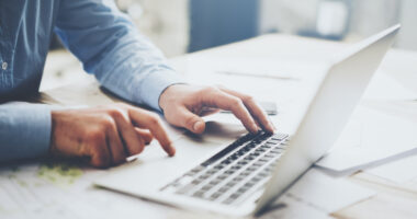 person typing on laptop keyboard