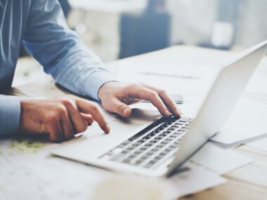 person typing on laptop keyboard