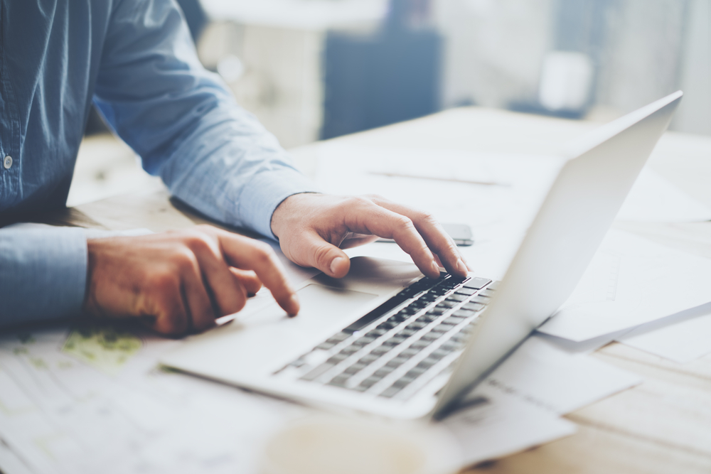 person typing on laptop keyboard