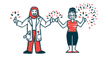A clinician and another person stand side by side, flashing a thumb's up sign.