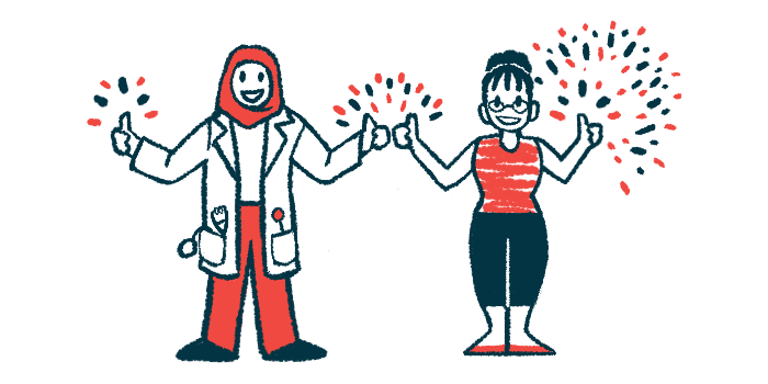 A clinician and another person stand side by side, flashing a thumb's up sign.