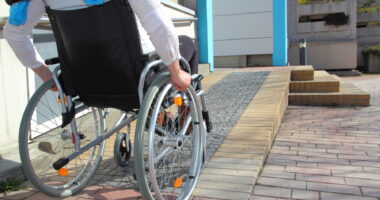 woman in a wheelchair using a ramp