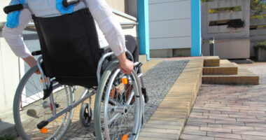 woman in a wheelchair using a ramp