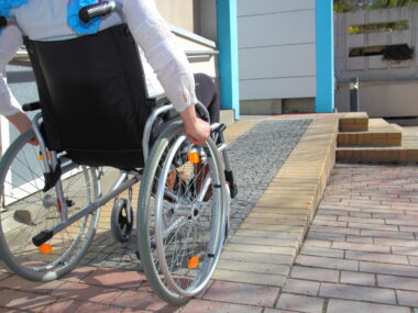 woman in a wheelchair using a ramp
