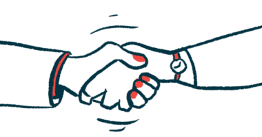 Two hands are seen clasped in a handshake.