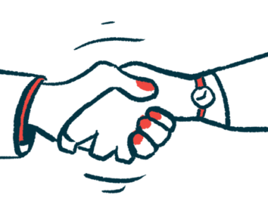 Two hands are seen clasped in a handshake.