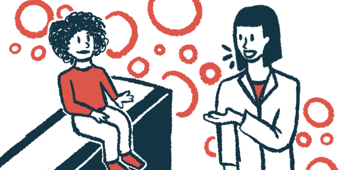 A child sits on an examining table as a clinician gestures toward her.