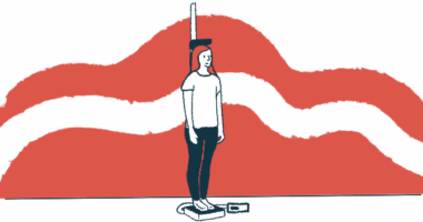 A person standing on a scale has their weight and height measured.