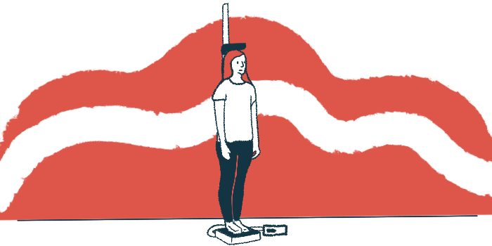 A person standing on a scale has their weight and height measured.