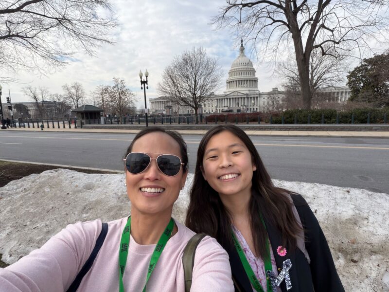Nell Choi, right, and her mom, Maggie Kang, take a selfie with the U.S. Capitol in the background while in Washington, D.C., for Rare Disease Week. (Photo by Maggie Kang)